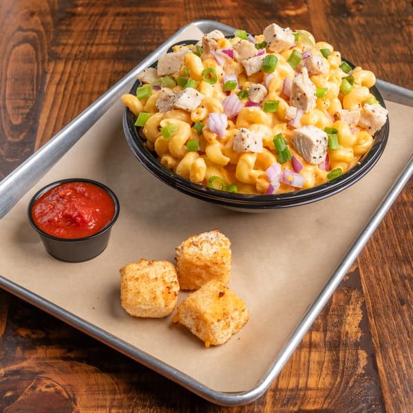 Mix & Mac Kitchen's mac and cheese with chicken, red onions, green onions, and a side of marinara and fried cheese curds.