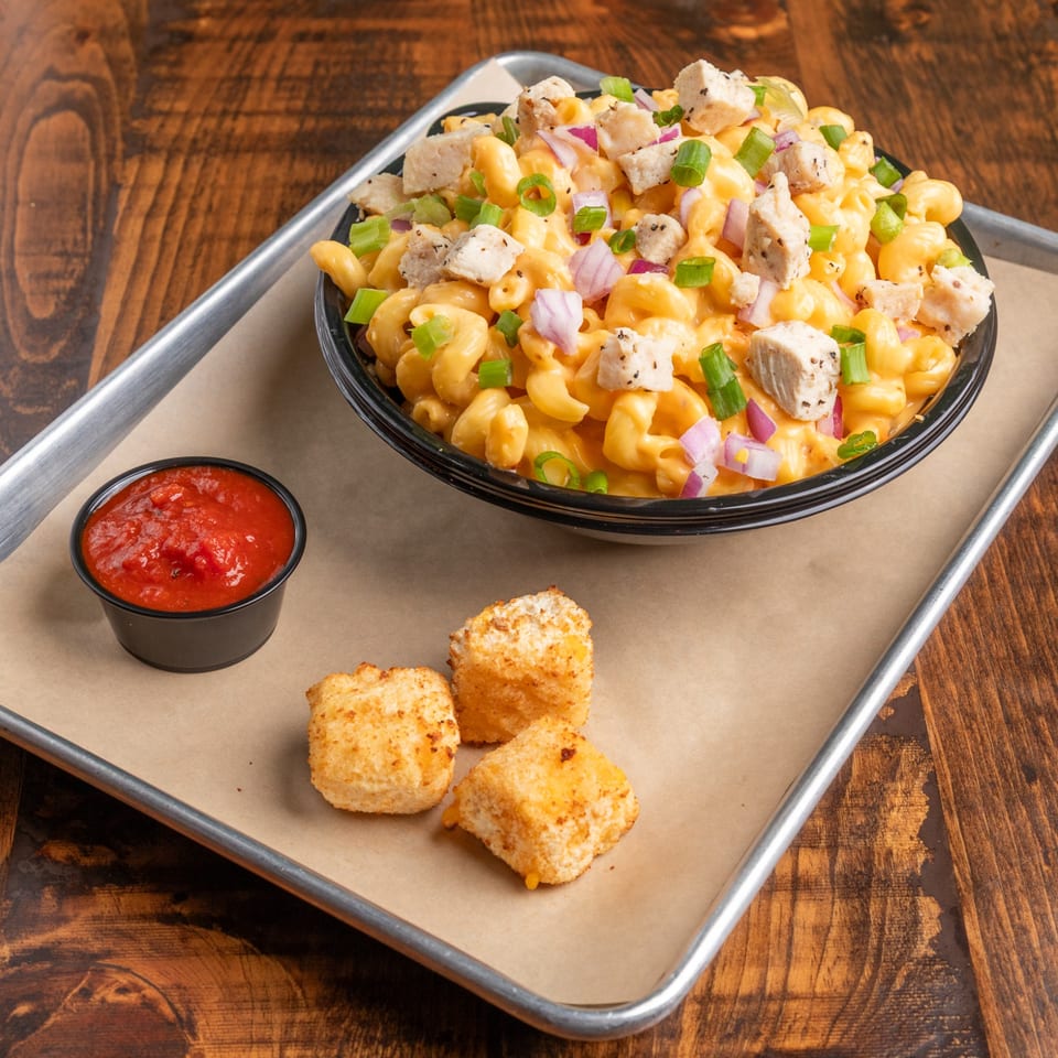 Mix & Mac Kitchen's mac and cheese with chicken, red onions, green onions, and a side of marinara and fried cheese curds.