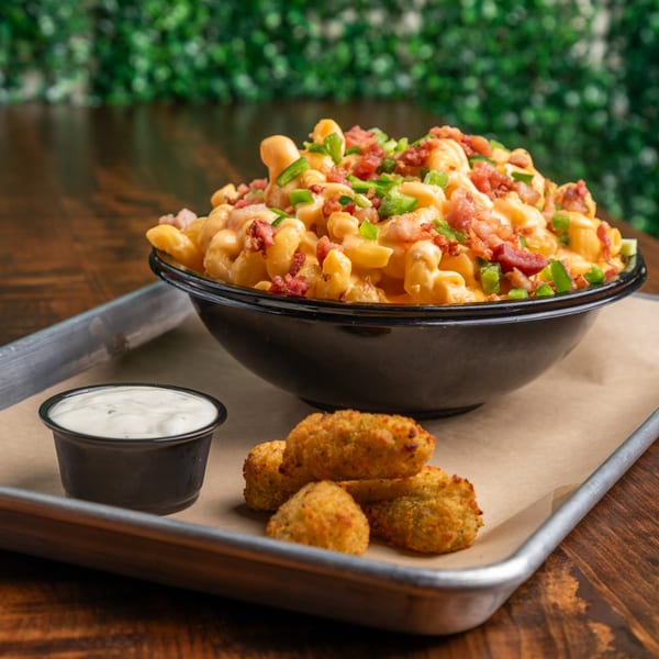 Mac and cheese with bacon and jalapeños, fried bites, and ranch on a metal tray.