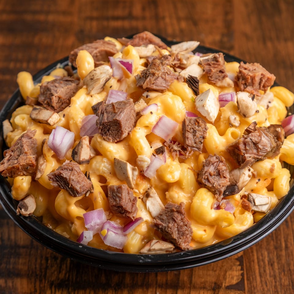 Close-up of Mix & Mac Kitchen's mac and cheese with beef, mushrooms, and red onions.